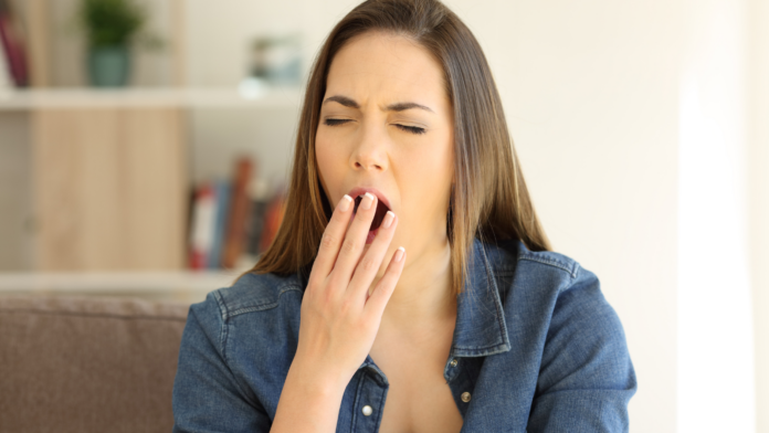 Woman feeling tired after eating due to possible blood sugar imbalance